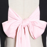 Longer blazer with a pink bow