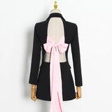Longer blazer with a pink bow