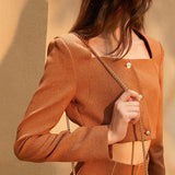 Short jacket and pleated skirt in brown