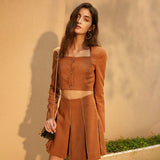 Short jacket and pleated skirt in brown