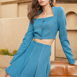 Short jacket and pleated skirt in teal