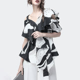 Printed ruffled black and white one-shoulder blouse