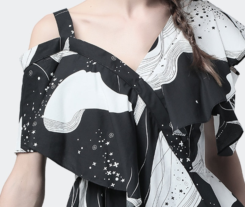 Printed ruffled black and white one-shoulder blouse