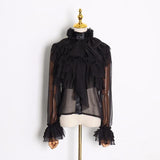 Ruffled bow mesh blouse in black